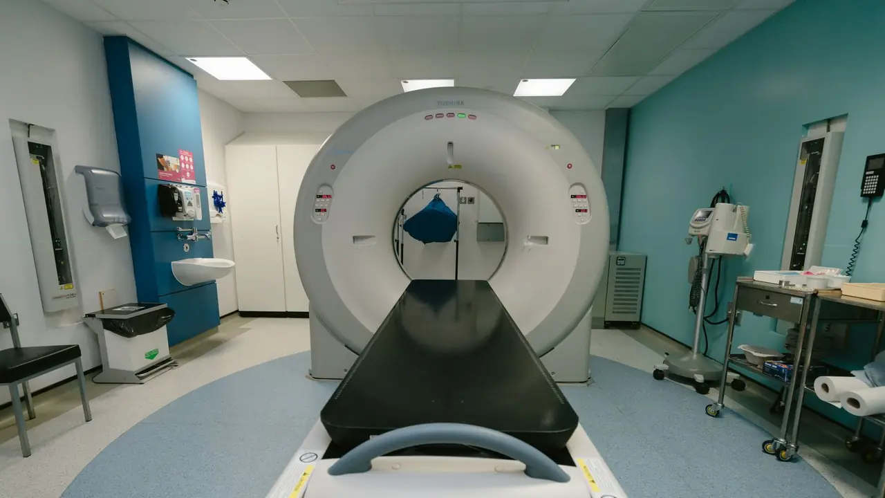 A diagnostic imaging scanner and its patient table in a hospital examination room